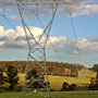 high voltage towers marching over the hill